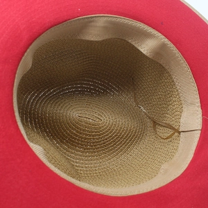 Detail of red panama hat interior with khaki woven crown and adjustable brown drawstring