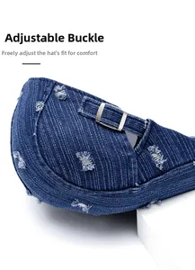 Detailed view of adjustable silver metal buckle on distressed denim newsboy cap