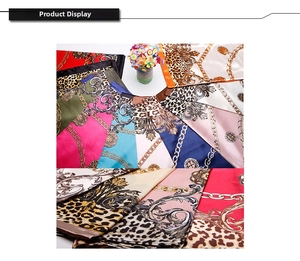 Close-up of leopard and baroque print silk satin scarves with glossy fabric texture