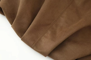 Detail shot of coffee brown faux suede jacket featuring durable double-stitch sewing seams