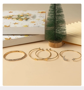 Set of four gold bracelets with rhinestones, heart, star, and moon charms for Christmas