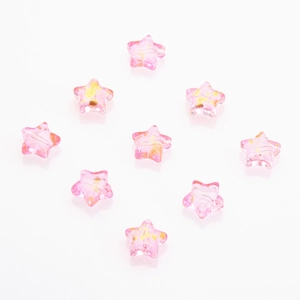 Detailed view of nine pink star-shaped crystal beads with gold glitter for DIY jewelry