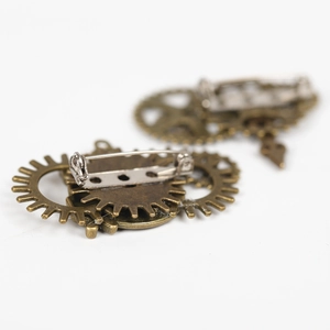 Macro shot of steampunk gear brooch with antique bronze finish and pin fastening detail