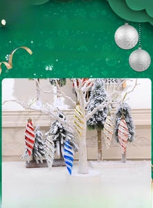 Detail of colorful spiral icicle Christmas ornaments with glitter finish on white branches