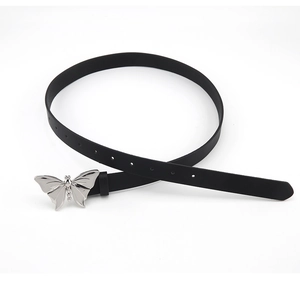 Close-up of black leather skinny belt featuring a silver butterfly metal buckle detail