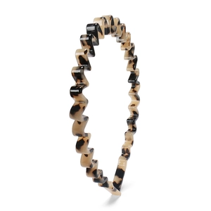 Elegant wavy tortoise shell headband with minimalist acetate design on white background