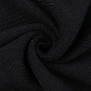 Nahaufnahme von schwarzem Strickstoff mit feiner Textur und spiralförmigen Details