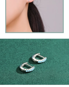 Detailed view of small s925 silver hoop earrings featuring tiny turquoise beads