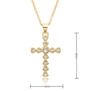 Detailed view of golden cross pendant with white zircons and hollow heart pattern