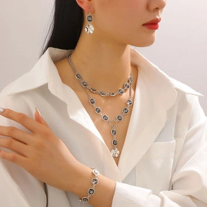 Silver layered necklace set with grey gemstones and hammer-textured metal pendants