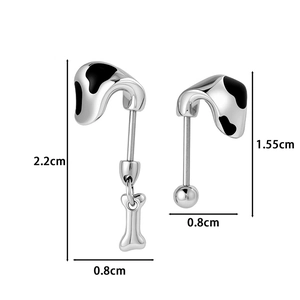 Silver puppy ear cartilage studs with black cow print and hanging bone charm