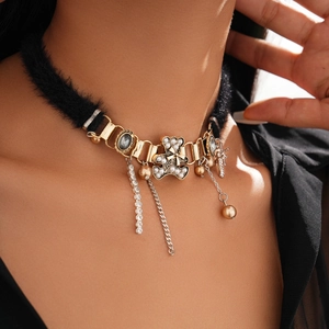 Detail of plush black choker with crystal bear pendant and pearl tassel accents