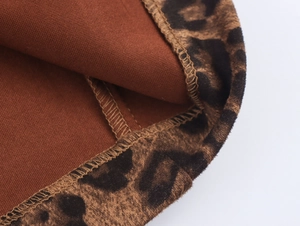 Macro shot of leopard print suede fabric with brown lining and professional stitching