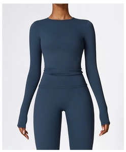 Detail view of dark teal long-sleeve yoga set with high-waisted leggings and matte finish