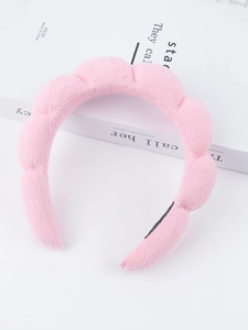 Detailed macro view of pink puffy cloud headband with soft terry texture and anti-slip grips