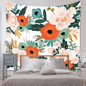 Detail of bohemian floral tapestry with colorful flower patterns hanging on bedroom wall
