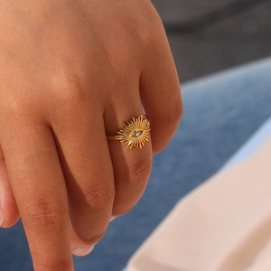 18K gold plated stainless steel sunburst ring with evil eye zircon on female model's finger