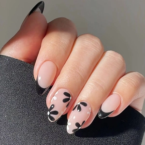 Almond shape press-on nails featuring black French tips and elegant floral patterns
