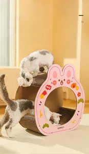 Detail of pink rabbit corrugated cardboard cat scratcher tunnel with interactive holes