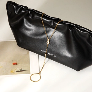 Elegant gold-plated finger chain bracelet with three sparkling zircons on black leather