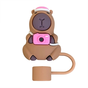 Detail of brown Capybara silicone straw cover with pink hat and camera for Stanley cup