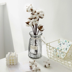 Pink dried cotton stems in grey glass vase for Nordic style minimalist home decor