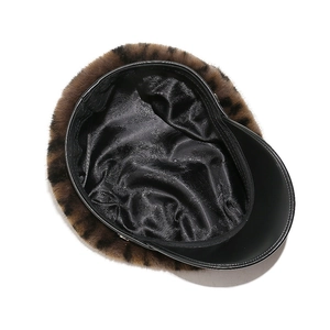 Detail of leopard print faux fur newsboy hat with black leather brim and paisley satin lining