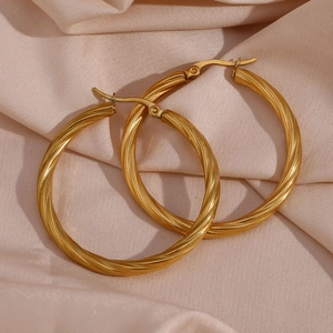 Detailed macro shot of 18K gold plated hoop earrings with textured spiral rope pattern