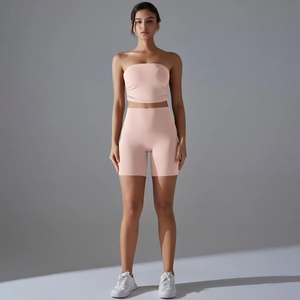 Detail of pink strapless tube top and high-waisted lifting yoga shorts workout set