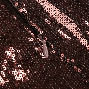 Close-up of deep red sequins and invisible zipper detail on a backless evening romper