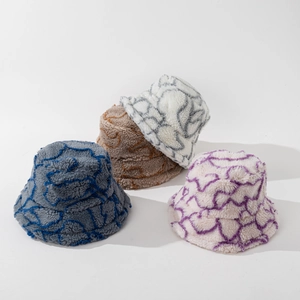 Stack of striped faux fur bucket hats showing diverse wavy color patterns for winter