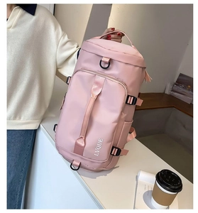 Pink cylinder travel bag detail with reinforced side buckles and water-resistant fabric