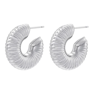 Detailed close-up of C-shaped silver hoop earrings with textured hollow twist design
