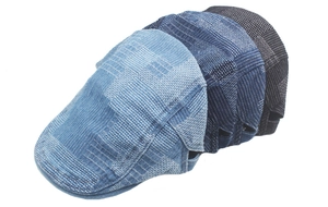 Detail of four vintage denim style berets showing textured woven fabric in various blue shades