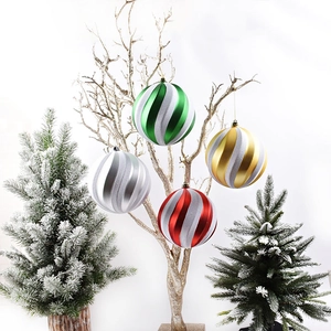 Set of 15cm painted Christmas balls with spiral glitter stripes hanging on golden branches