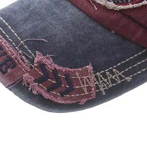 Macro shot of distressed washed cotton baseball cap with raw edges and embroidery detail