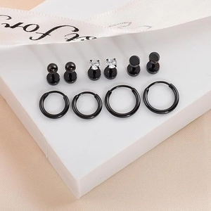 10-piece black stainless steel earring set with studs and hoops on geometric stand