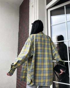Detail of oversized plaid shirt showing loose fit cut and textured fabric from the back
