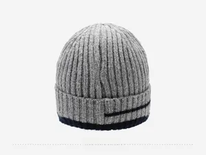 Detailed back view of a grey rib-knit beanie with blue stripe accent and thick wool texture