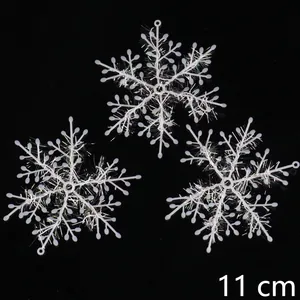 Detail view of 11cm white laser snowflake ornaments with sparkling glitter filaments
