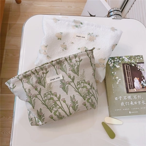 Close-up of floral pattern knit cosmetic bags with zipper and simple wish label