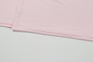 Detailed close-up of pink dress hem featuring professional double-needle stitching
