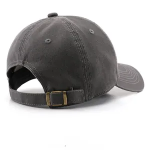 Detail view of washed cotton baseball cap with adjustable bronze metal buckle strap