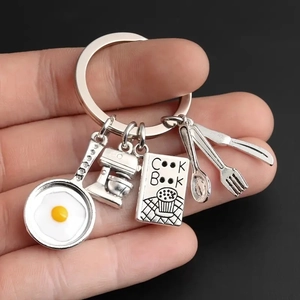Cooking theme keychain with frying egg pan, mixer, cookbook, and cutlery charms