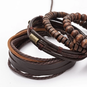 Close-up of multi-layer men's bracelet with dark brown leather and wooden beads