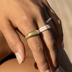 Stacked style of 18K gold rippled ring with pink and white enamel bands and zircons