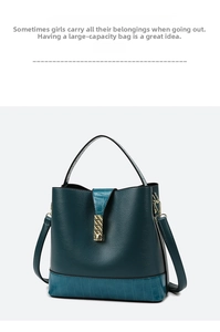Detail view of dark green leather tote with lychee pattern and gold metal hardware lock