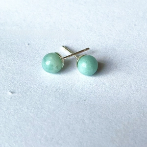 Close-up of 6mm green natural crystal stone beads on S925 silver stud earrings