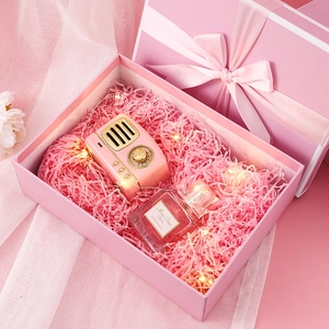 Pink gift box set with mini speaker, perfume, LED lights, and silk ribbon bow