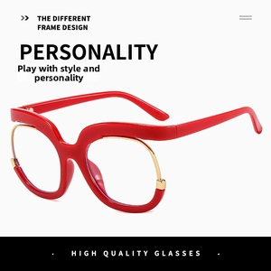 Macro shot of red wavy frame glasses with gold metal wire trim and unique aesthetic